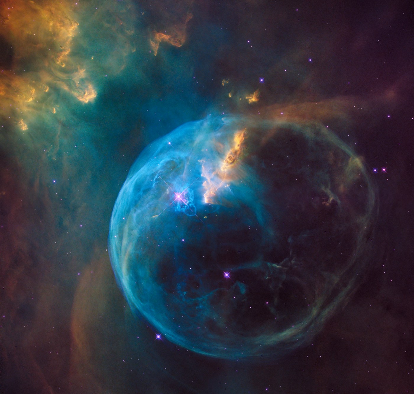 Blue and violet clouds of gas surrounding a luminous bubble nebula